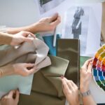 Hands of creative designers choosing fabric and color for new fashion collection