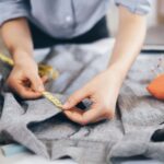 The tailor taking measurements of jacket