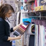 Woman designer, decorator chooses fabrics for curtains